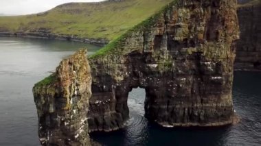 Aerial drone view on Drangarnir Sea Stack in the Atlantic ocean, Faroe Islands. High quality 4k footage. Rock formations.