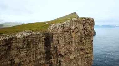Aerial view of Slave cliff or Traelanipan and Sorvagsvatn lake or Leitisvatn, Biggest lake in Faroe Islands. High quality 4k footage. Amazing nature. Huge cliffs. Lake above the ocean.