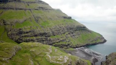 Aerial view of a lagoon in Saksun village, Faroe Islands. Lagoon in beautiful green nature in Saksun. Mist faroese nature. High quality 4k footage.