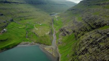 Aerial view of a lagoon in Saksun village, Faroe Islands. Lagoon in beautiful green nature in Saksun. Mist faroese nature. High quality 4k footage.