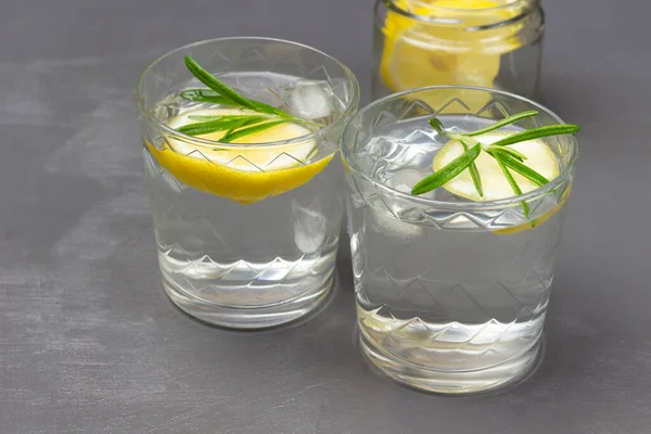 Two glasses with lemon drink. Top view. Grey background