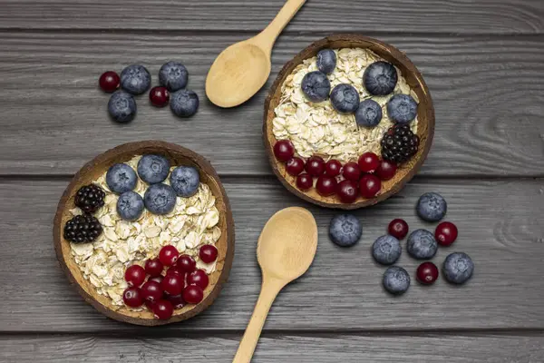 Whole Oats Blueberries Cranberries Coconut Bowls Two Wooden Spoons Berries — Stock Photo, Image