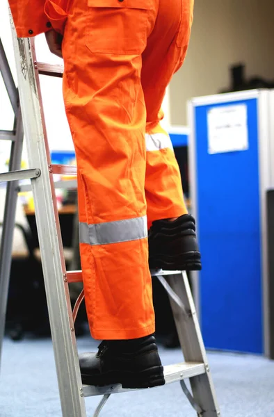 Worker Climbing Holding Ladder Wearing Safety Shoes Orange Coverall Fixing — 图库照片