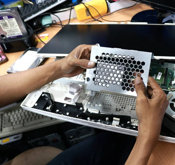 Photo of the activity of repairing electronic equipment, repairman repairing a broken computer