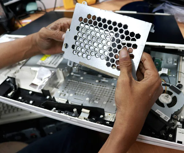 Photo of the activity of repairing electronic equipment, repairman repairing a broken computer