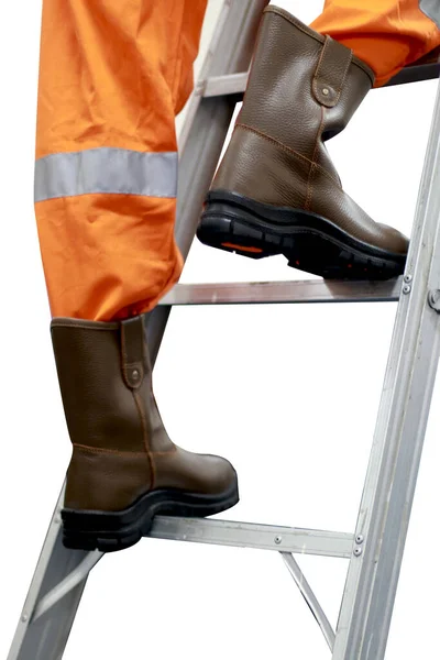 The workers are climbing the stairs wearing safety shoes made of leather to protect their feet from accidents at work. Safety footwear is part of the safety equipment