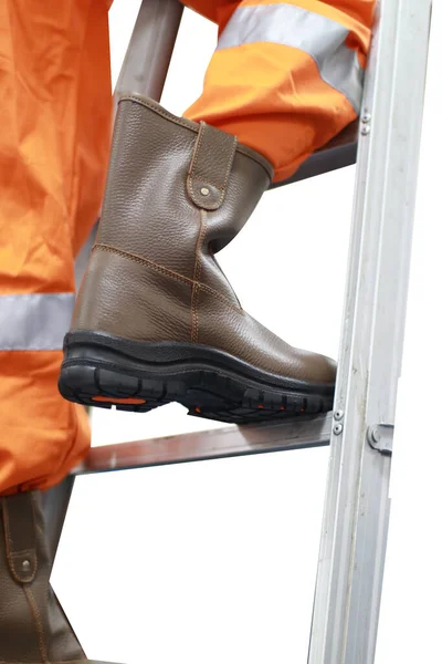 The workers are climbing the stairs wearing safety shoes made of leather to protect their feet from accidents at work. Safety footwear is part of the safety equipment