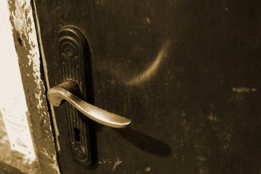 Doorknob and keyhole on an old brown door