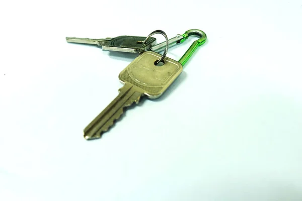 Photo of two silver house keys made of steel on a white background