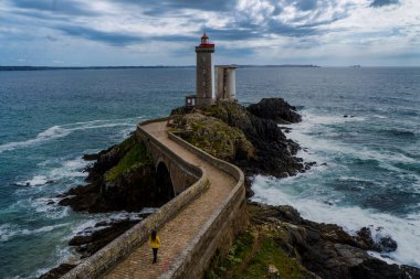 Deniz feneri du petit minou Sarı ceketli bir kadın.