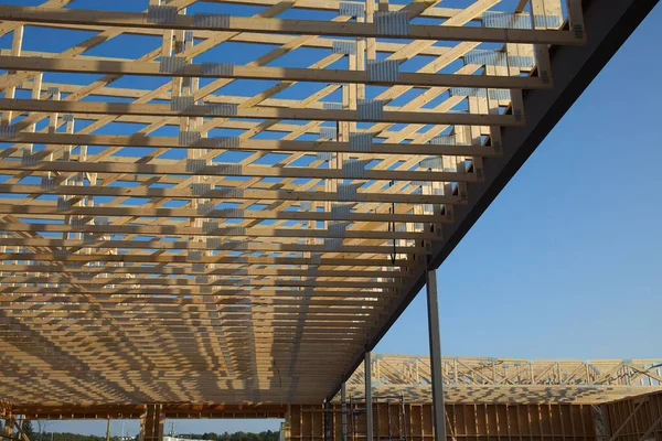 house roof under construction wood frame structure beams planks unfinished building