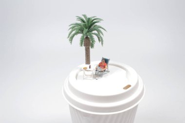 Plaj sandalyesinde mini mutlu, tatil konsepti.