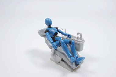  dentist with his assistant examining  patient in dentist office