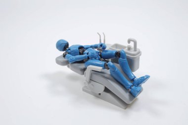  dentist with his assistant examining  patient in dentist office