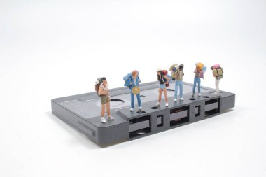 the mini people backpacker walking on Compact Cassette
