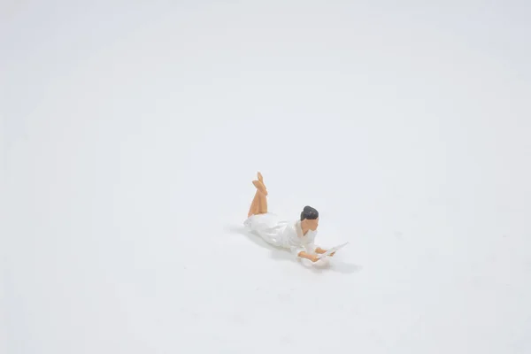 Figure Laying Holding Book Isolated White — Stok fotoğraf
