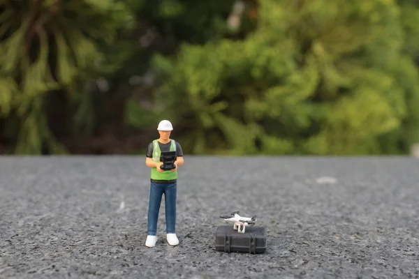 the mini scale of the Specialists Use Drone on Construction Site.