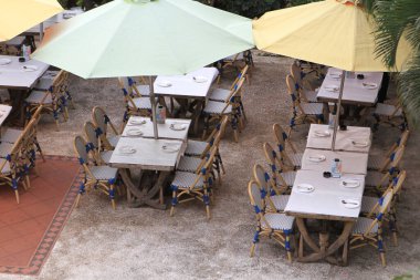 Empty tables in between dining hours along a hk cobblestone alley
