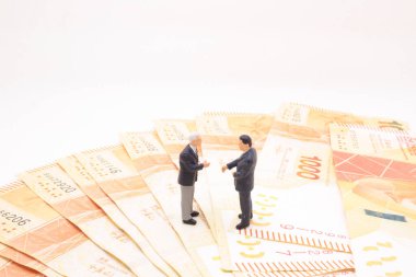 a mini of figure business man  on the bank note