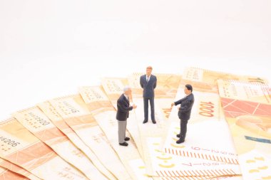 a mini of figure business man  on the bank note