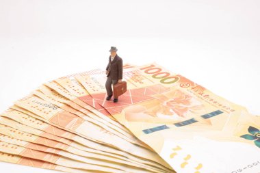 a mini of figure business man  on the bank note