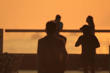 15 OCT 2011 Silhouettes of people walking at the  Promenade, hk