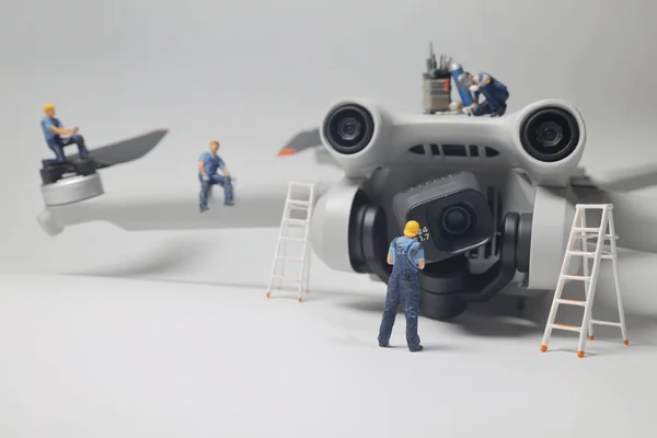 a Team of engineers inspects the engines of a drone