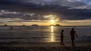 Tayland 'daki Koh Chang adasında gün batımında yoğun bir plajda zaman aşımı.