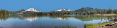 Panorama of snowcapped mountains and Sparks Lake near Bend Oregon clipart