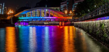 Bridge illuminated in rainbow colors in Singapore at night