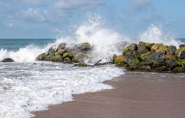 Waves crashing over a breakwater in Sri Lanka