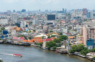 A boat on the Chao Phraya River and downtown Bangkok Thailand