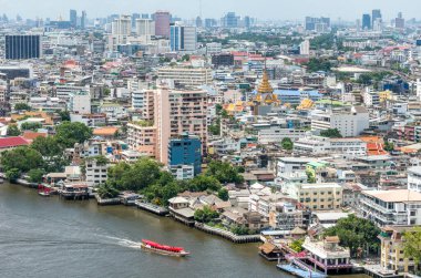 A boat on the Chao Phraya River and downtown Bangkok Thailand