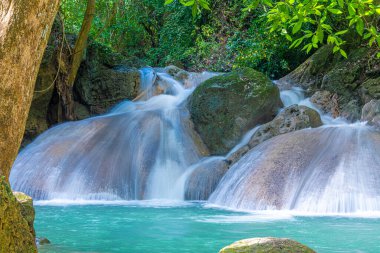 Etherical colors and a waterfall at Erawan National Park in Thailand