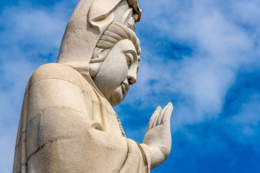 Giant Buddha statue at a temple in Kanchanaburi Thailand