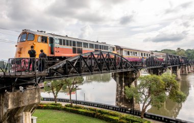 Locomotive crossing the landmark bridge over the River Kwai at Kanchanaburi Thailand