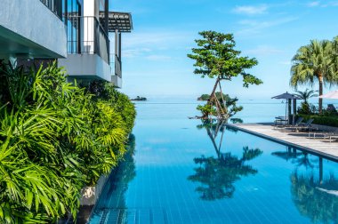 Reflections in a resort infinity pool in tropical Thailand