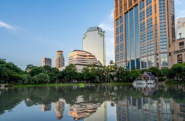 Skyscrapers reflecting in a lake at Queens Park in the Phrom Phong district of downtown Bangkok