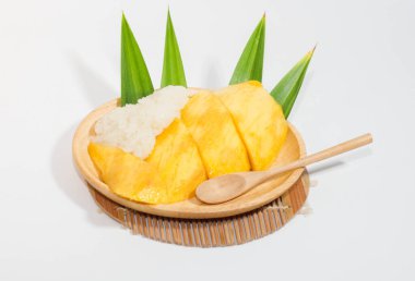 Tahta bir tabakta mango pilavı ve tahta bir kaşık, beyaz arka plan..