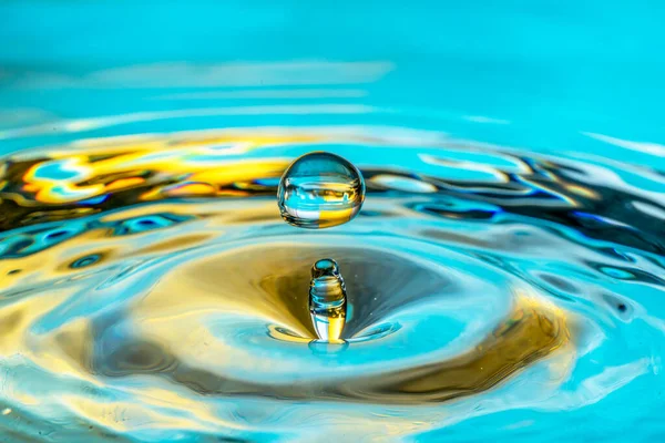 Water Drop Splash Isolated Turquoise Background —  Fotos de Stock