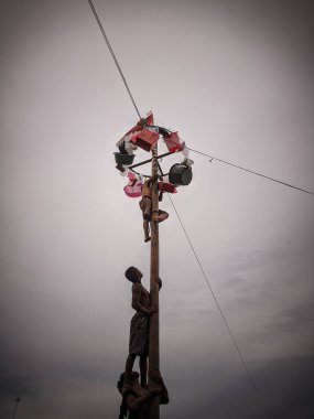 the excitement of children and adults taking part in the areca climbing competition to enliven the independence day of the republic of Indonesia, east kalimantan, indonesia, august, 14,2022