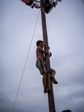 the excitement of children and adults taking part in the areca climbing competition to enliven the independence day of the republic of Indonesia, east kalimantan, indonesia, august, 14,2022