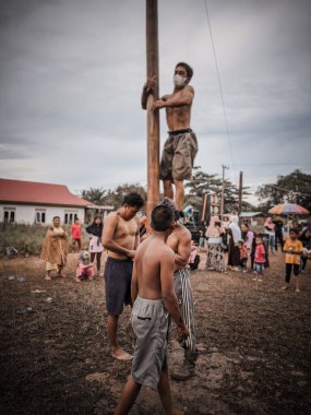 the excitement of children and adults taking part in the areca climbing competition to enliven the independence day of the republic of Indonesia, east kalimantan, indonesia, august, 14,2022
