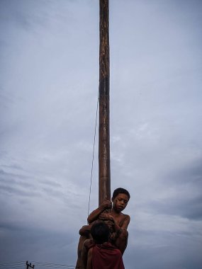 the excitement of children and adults taking part in the areca climbing competition to enliven the independence day of the republic of Indonesia, east kalimantan, indonesia, august, 14,2022