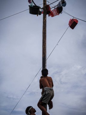 the excitement of children and adults taking part in the areca climbing competition to enliven the independence day of the republic of Indonesia, east kalimantan, indonesia, august, 14,2022