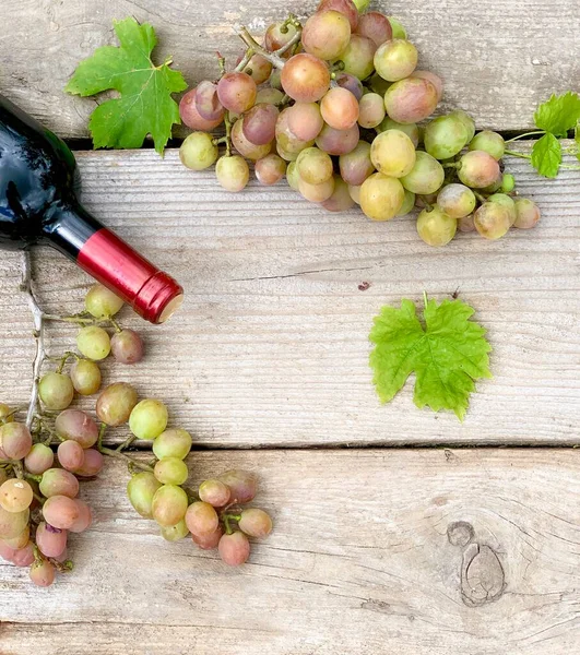 grapes and wine close-up on a wooden background