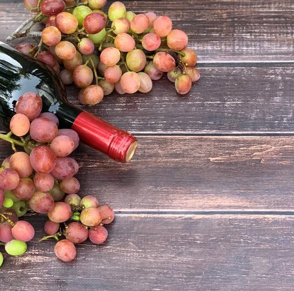 grapes and wine close-up on a wooden background