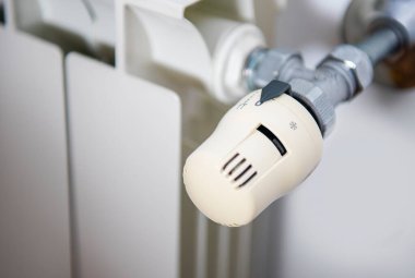 Close up of central heating system temperature radiator with thermostat control