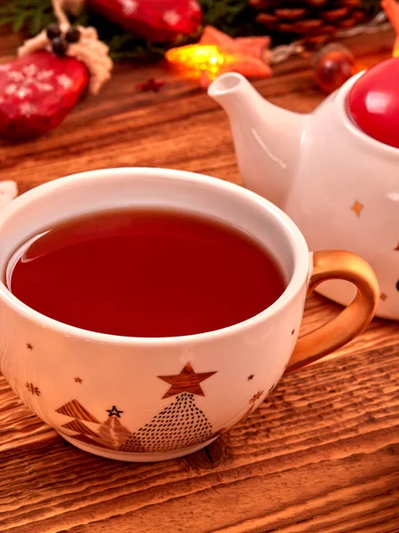 Christmas background with Christmas decoration and tea on wood