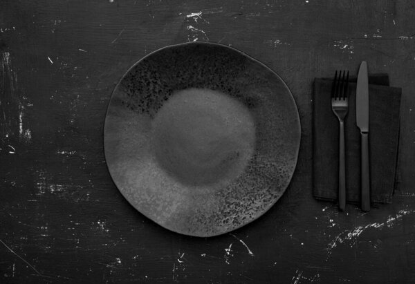Black empty plate on table